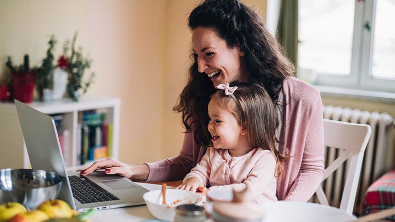 Mom with Daughter smiling at the computer