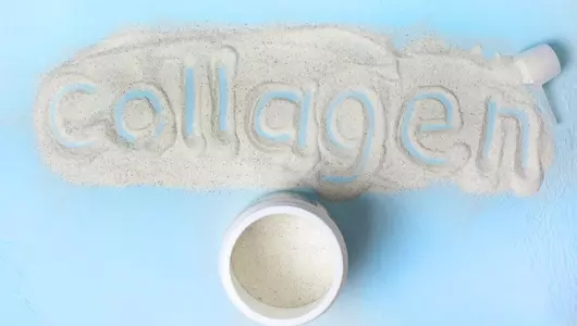 Collagen powder on countertop with the word collagen spelled in it