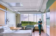 Woman preparing hospital room for patient.
