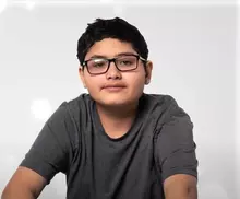 Teenage boy wearing glasses.