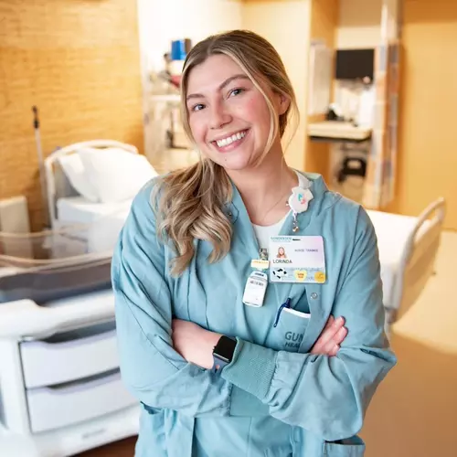 Nurse intern lorinda schwartz smiling in hospital room.