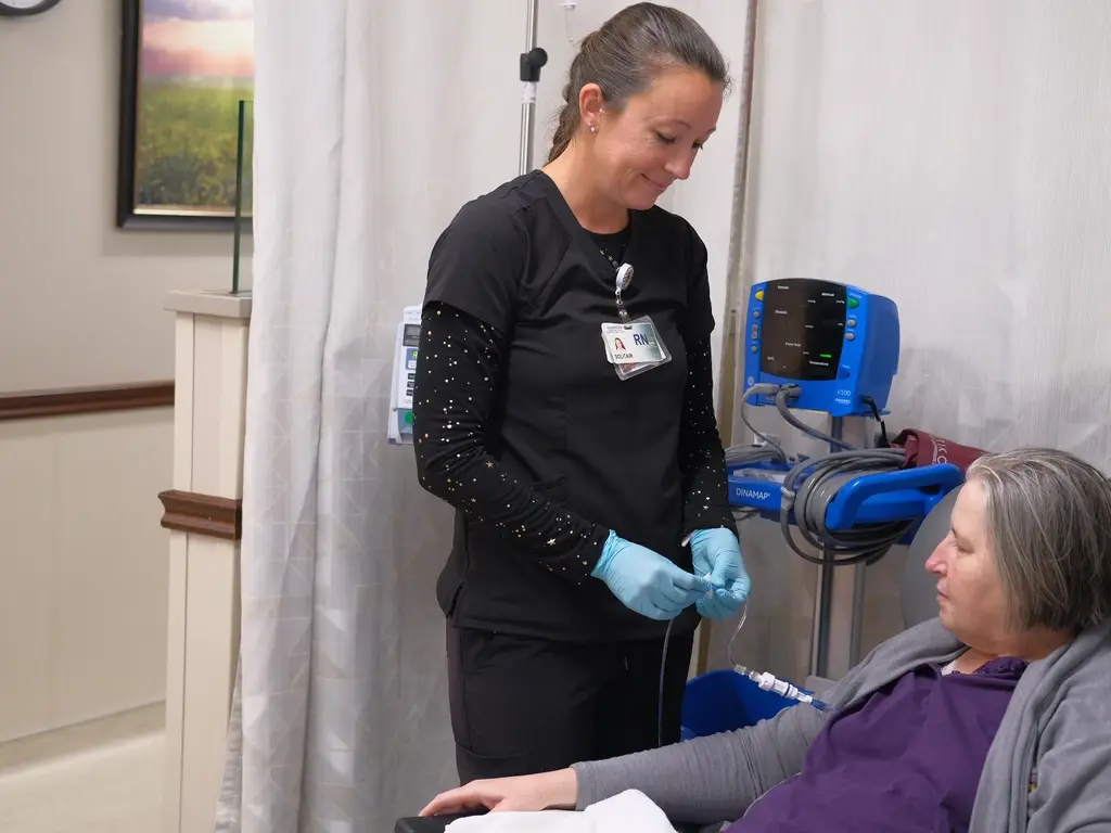 Nurse caring for patients IV in Infusion Center.