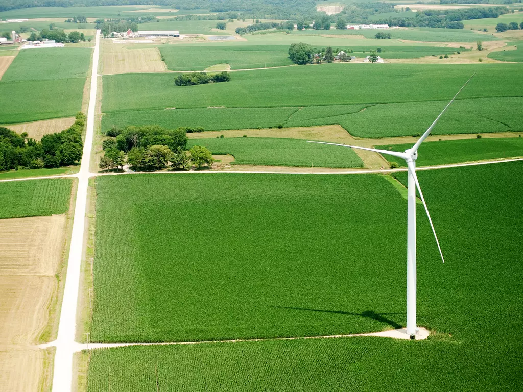 Wind turbine on farmland.