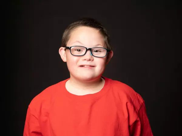 young man smiling in red shirt