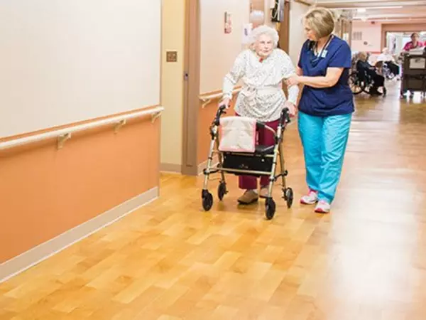 Nurse walking with an elder woman