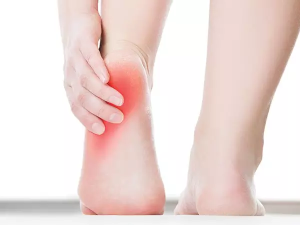 person touching painful heel