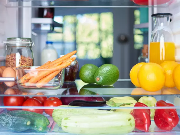 fruits and vegetables on a refrigerator shelf