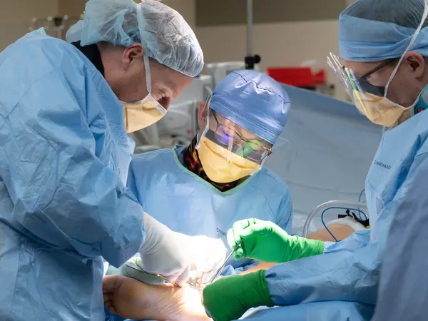 Podiatry residents operating on a foot.
