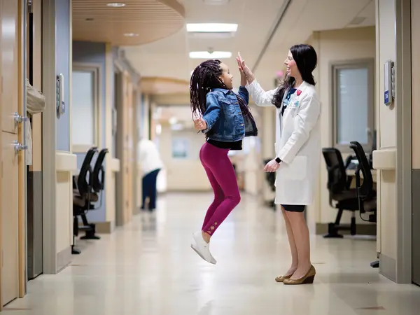Stepanie-Neuman-MD-high-five-with-child.jpg