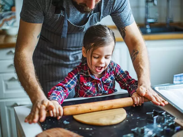 father-and-daughter-rolling-dough