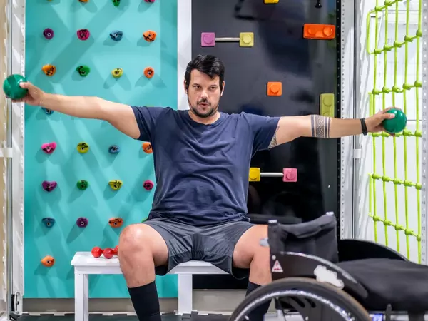 Man with wheelchair doing physical therapy.
