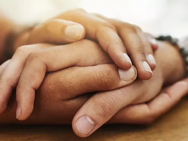 person holding the hand of another in both hands