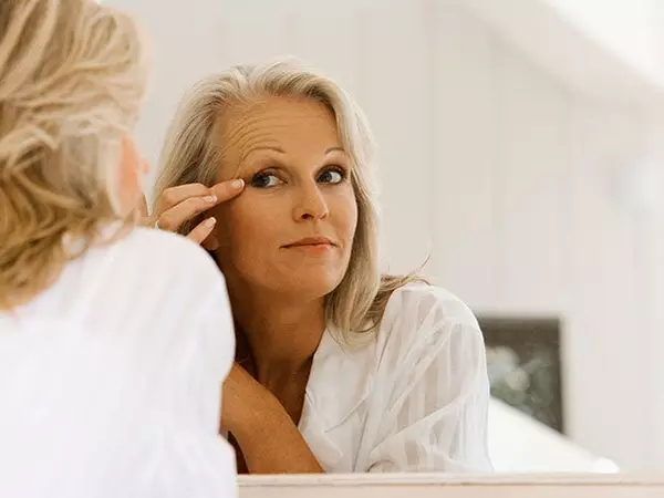 older woman looking in the mirror