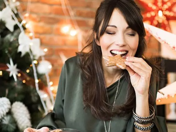 woman eating Christmas cookie