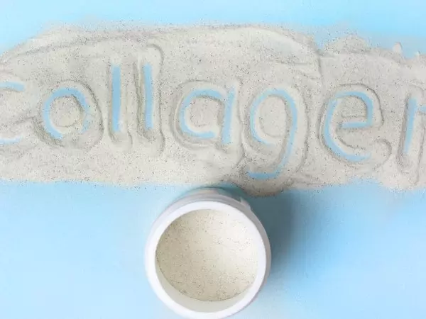 Collagen powder on countertop with the word collagen spelled in it