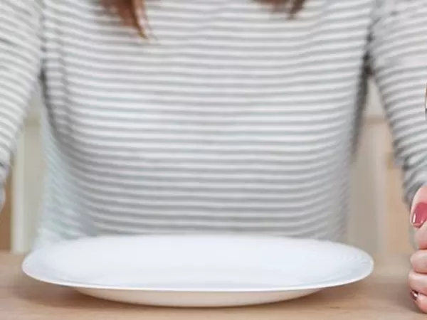 What is intermittent fasting-woman with dinner plate