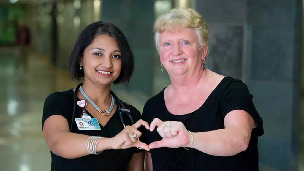 Sam Setty, MD and Deb Saphner creating heart with hands