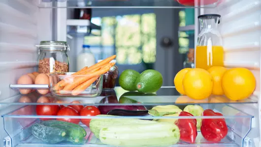 fruits and vegetables on a refrigerator shelf