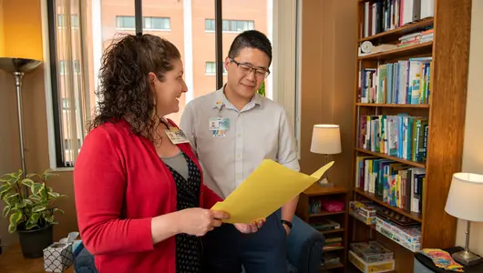 Psychologists collaborating with patient file in office.