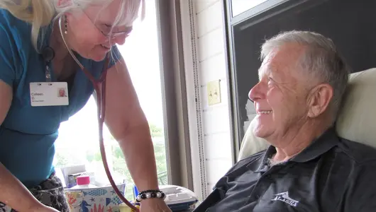 Nurse taking patients blood pressure.