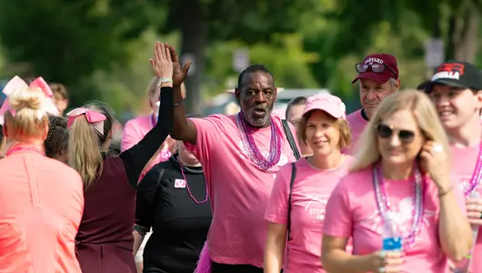 Man and woman exchanging high fives at fundraising event.