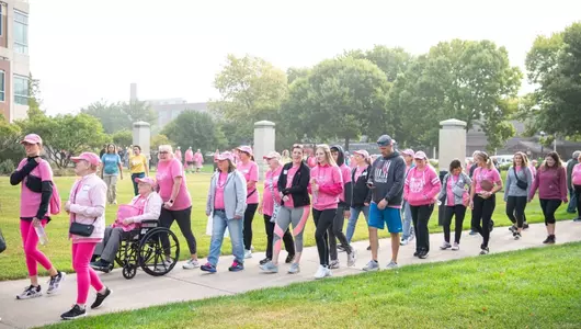 Walkers for giving event dressed in pink for breast cancer survivors.