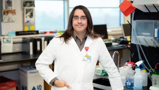 Lyme disease researcher Arick Sabin in white coat at research lab.jpg