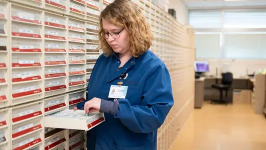 Researcher with specimen slide inside cancer Biobank.