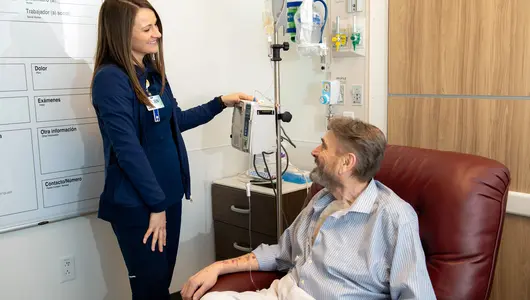 Gundersen Tri-County registered nurse helping patient in hospital room.