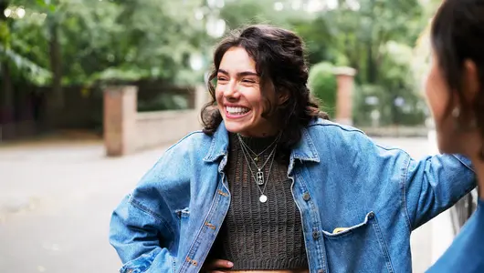 Woman laughing, with friend