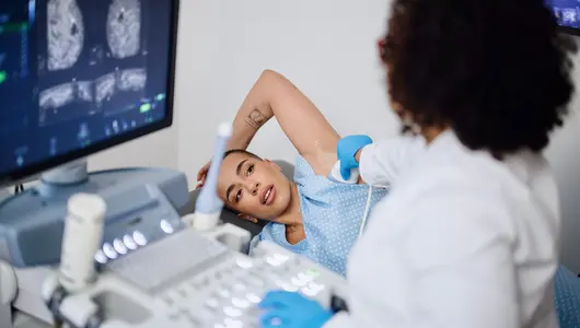 A young woman is doing a breast ultrasound for preventive breast cancer care