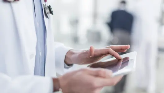 Close-up of doctor using a digital tablet.