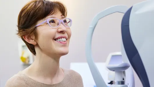 Woman getting her eyesight measured to buy new glasses