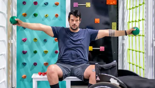 Man with wheelchair doing physical therapy.