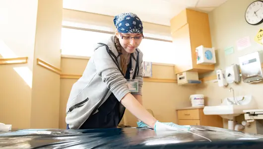 Environmental-assistant-cleaning-patient-room.jpg
