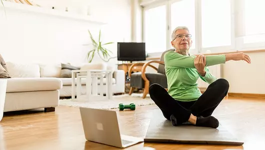 older woman exercising virtually