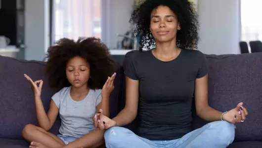 Woman and daughter in meditation poses