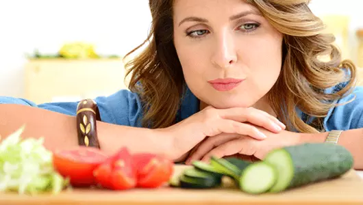 woman deciding to eat vegetables-coming out of your food comfort zone
