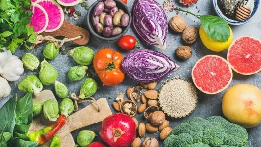 overhead shot of a table full of fruits, vegetables, and nuts