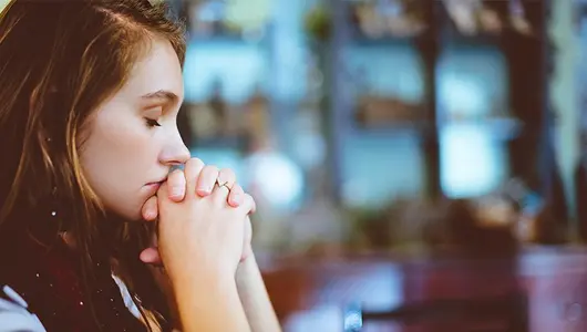 woman sad with head on hands