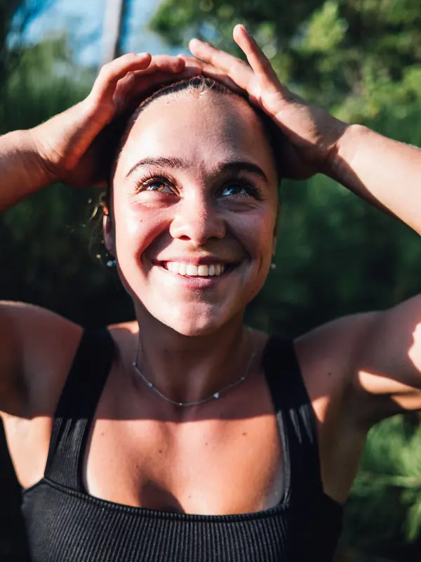 Portrait of young muscular woman in nature