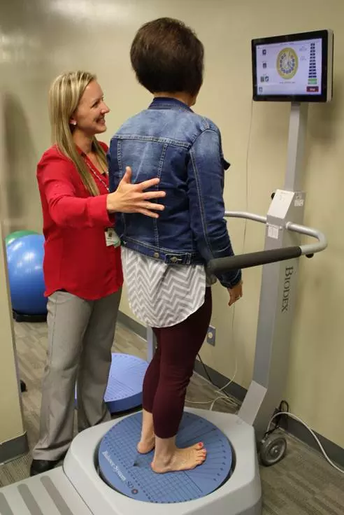 Rehab Services Director Robyn Moritz demonstrates the Biodex Balance System