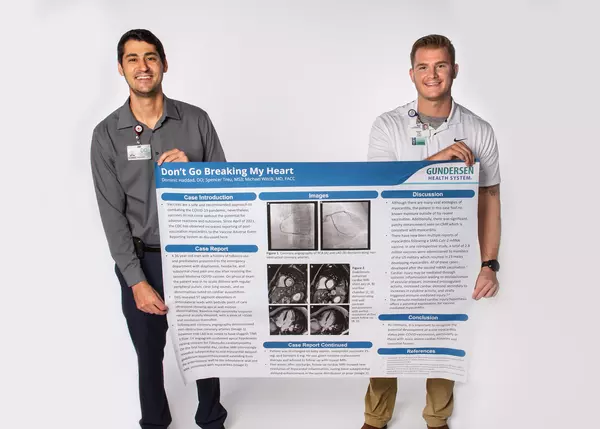 internal-medicine-residents-holding-research-poster
